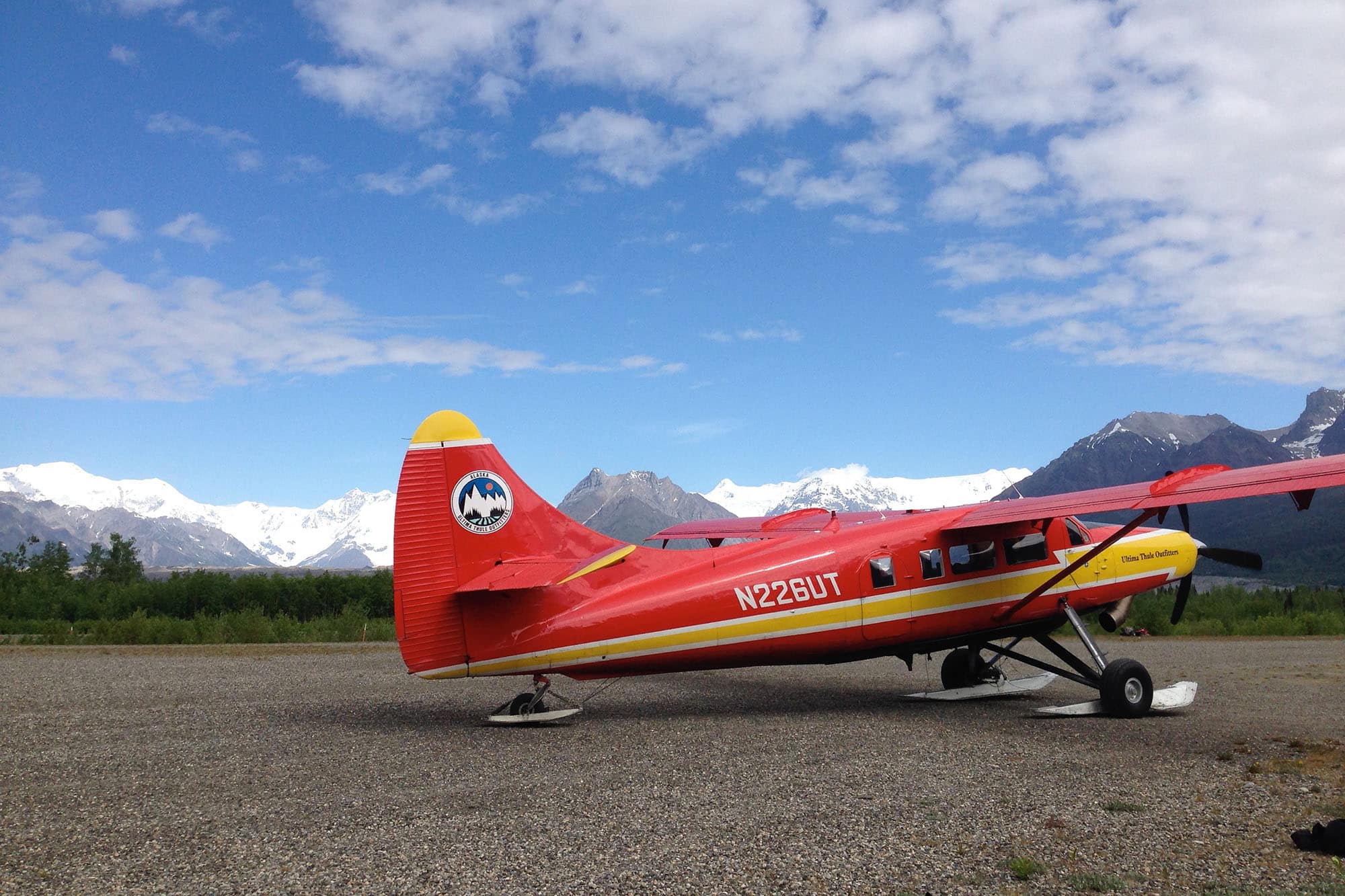 Red bush plane with blue sky