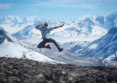 Spencer jumping in front of mountains