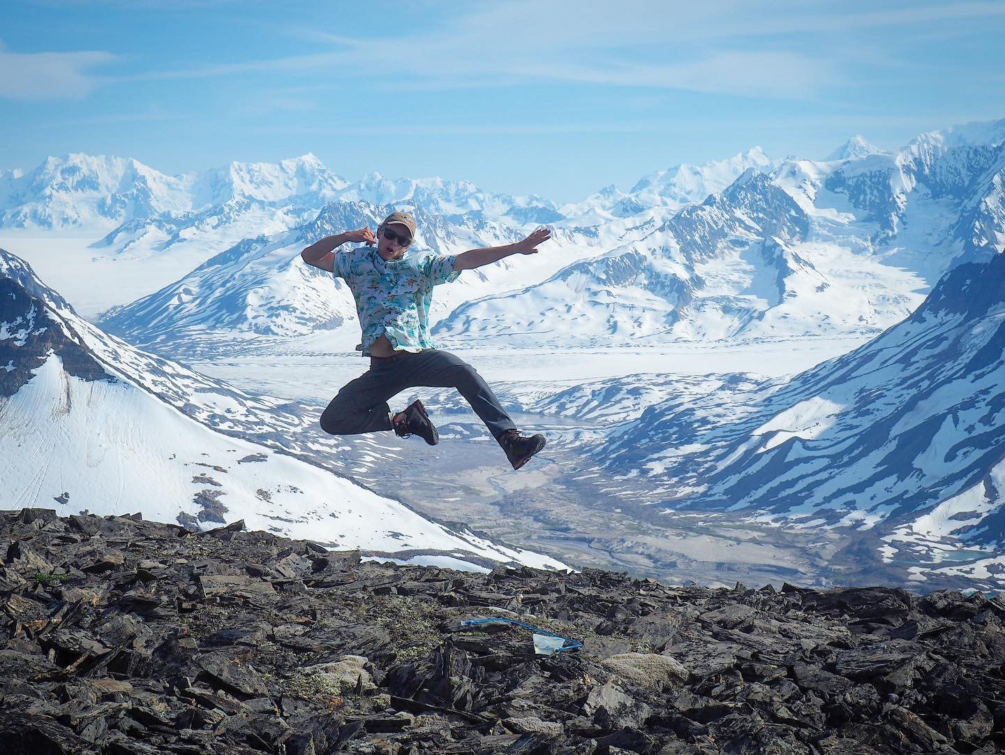 Spencer jumping in front of mountains